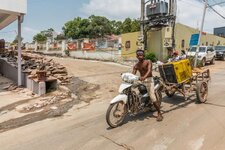sihanoukville-cambodia-march-half-naked-young-man-white-motorbike-pulling-old-brown-trailer-ye...jpg